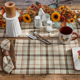 Toffee & Elm Plaid Placemats Set of 4 Fall table setting with plaid placemats, candles, and a mug on a wooden table.