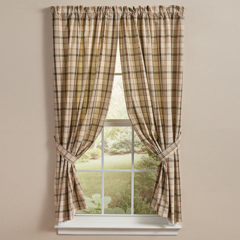Toffee & Elm Plaid Short Panel Curtains 63" with a gathered top rod pocket, tied back on either side of a white window to reveal a garden view outside.