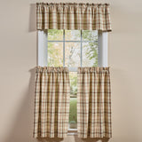 Toffee & Elm Plaid Valance and Cafe Tiers in a beige, green and brown plaid pattern, styled on a window against a beige wall.