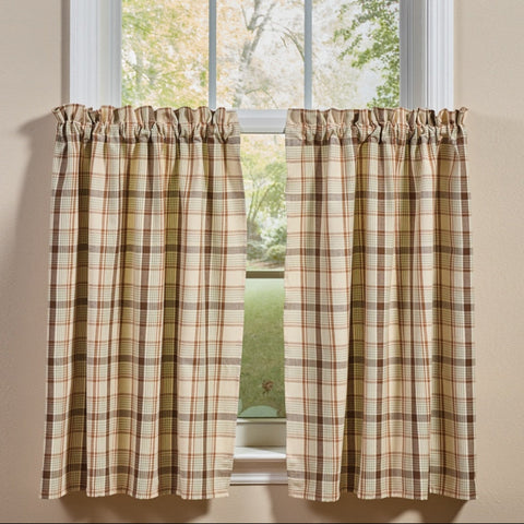 Toffee & Elm Plaid Cafe Tiers two tier panels in a beige green and brown plaid pattern, shown hanging on a white window frame against a beige wall.