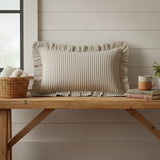 Farmstead Charcoal & Dark Creme Ticking Stripe Throw Pillow Rectangular pillow on farmhouse bench next to shiplap wall.