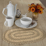 White ceramic teapot, mug, and bowl on a Stonebrook Braided Oval Placemat with a wooden surface background.
