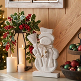 Snowman display with a natural wood wall