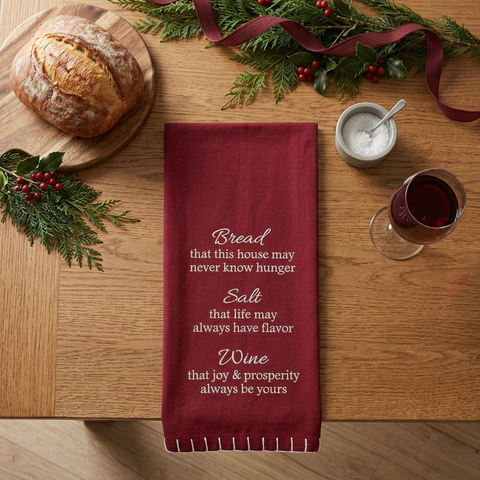 Square overhead Christmas scene featuring the Bread Salt & Wine Dishtowel on a wood kitchen table with bread, salt, and a wine glass