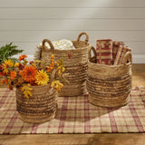 Brinkley Rattan Round Baskets Set of 3 — lifestyle view with throw blanket, fall florals and woven rug, all three sizes on hardwood floor