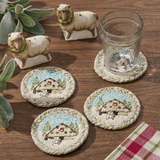 Christmas Barn coasters on a warm walnut tabletop