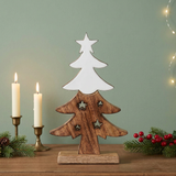 Wooden Christmas tree figurine with a sage green wall and candle accents