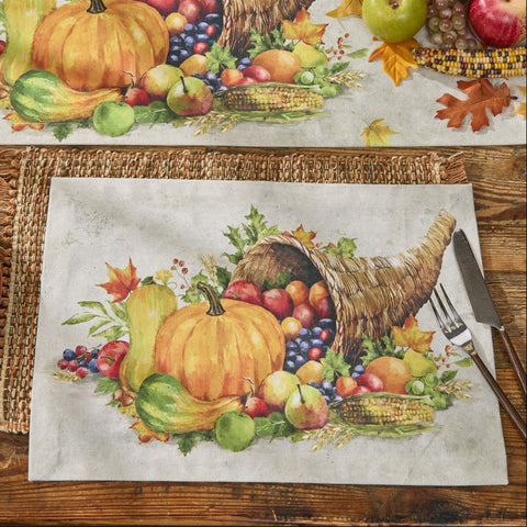 Cornucopia Fall Placemats Set of 4Decorative Thanksgiving table runner and placemats with pumpkins, fruits, and cornucopia on a wooden table.