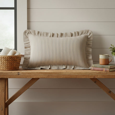 Farmstead Charcoal & Dark Creme Ticking Stripe Throw Pillow Rectangular pillow on farmhouse bench next to shiplap wall.