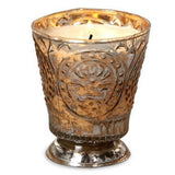Fleur de Lys Tumbler Hand-Poured Soy Scented Candle - Champagne in an ornate, textured metallic silver and gold glass holder with a footed base, shown against a plain white background.