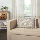 Graycie Give Thanks Fall Accent Pillow displayed on a cream linen sofa in a bright farmhouse room with shiplap wall and wood side table