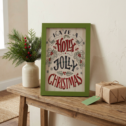 Square lifestyle image with the Christmas sign resting on a console table