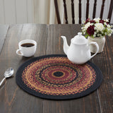 Heirloom Farm Braided Trivet 15" Set of 3 styled on dark farmhouse wood dining table with white teapot, coffee cup, and burgundy red and white floral arrangement