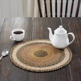 Kettlehurst Braided Trivet 15" Set of 3 Round woven placemat on a wooden table with a teapot and cup.
