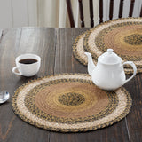 Kettlehurst Braided Trivet 15" Set of 3 Round woven placemats on a wooden table with a teapot and cup.