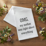 OMG My Mother Was Right About Everything Flour Sack Towel folded on a wood surface surrounded by wildflowers and lavender