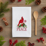 Peace Cardinal Embroidered Waffle Towel White towel with red cardinal bird, holly, and snowflake design with Christmas floral and cinnamon stick accents.