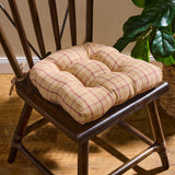 Simmons Plaid Chair Cushion Pad tied to a dark wood farmhouse dining chair with a fiddle leaf fig in the background