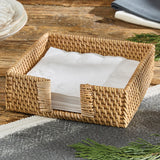 Rattan Napkin Holder woven basket with white napkins on a wooden table