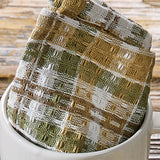 Sage & Mustard Dishcloth Set of 3 patterned towel on a white cup with a wooden background