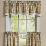 Sage & Mustard Plaid Layered Valance in a sage green, light mustard, putty brown, and white plaid pattern, shown hanging on a white-framed window against a beige wall.