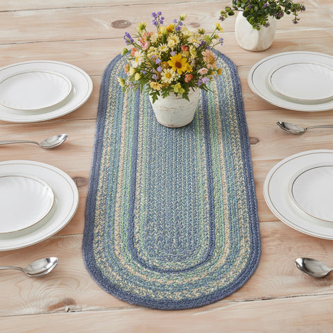 Sea Glass Braided Table Runner blue and green table runner with a floral arrangement on a wooden table.