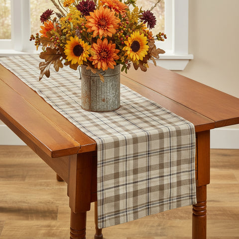 Tinderbox Brown Plaid Table Runner styled on a farmhouse wood dining table with a fall sunflower and mum bouquet in a galvanized bucket — 100% cotton plaid runner in brown and oatmeal