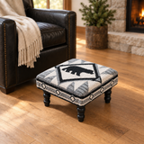 Tribal Bear Hooked Stool with revised scale beside the black chair