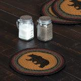 Wattsyn Bear Braided 8" Trivet Set of 3 — lifestyle view showing stenciled black bear jute trivet on dark wood table with mason jar salt and pepper shakers
